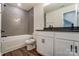 Bathroom featuring gray tiled shower, vanity with modern fixtures, and wood-look flooring at 108 Ellsworth Rd # 40, Mooresville, NC 28115