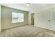 Spacious bedroom with light walls, plush carpet, and a window offering natural light at 108 Ellsworth Rd # 40, Mooresville, NC 28115