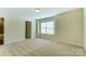 Bright bedroom with carpeted floors, and a door to an ensuite bathroom at 108 Ellsworth Rd # 40, Mooresville, NC 28115