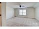 A spacious carpeted bedroom with a ceiling fan and large window at 108 Ellsworth Rd # 40, Mooresville, NC 28115