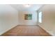 Cozy bedroom offers neutral carpet, a serene atmosphere and natural light from a large window at 108 Ellsworth Rd # 40, Mooresville, NC 28115