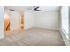 Spacious carpeted bedroom with a ceiling fan and two entryways leading to other rooms at 108 Ellsworth Rd # 40, Mooresville, NC 28115