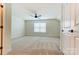 Bedroom features large window, modern ceiling fan, neutral walls and plush carpet at 108 Ellsworth Rd # 40, Mooresville, NC 28115