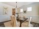 Bright dining room featuring a modern chandelier and ample seating for Gathering gatherings at 108 Ellsworth Rd # 40, Mooresville, NC 28115