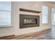 Modern fireplace with a sleek design and a wooden mantel, illuminated by natural light from nearby windows at 108 Ellsworth Rd # 40, Mooresville, NC 28115