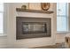 Modern fireplace with a dark surround and a wooden mantel shelf at 108 Ellsworth Rd # 40, Mooresville, NC 28115