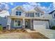 Charming two-story home featuring gray siding, stone accents, and a welcoming covered front porch at 108 Ellsworth Rd # 40, Mooresville, NC 28115