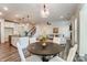 Open concept living room, dining area, and kitchen layout with wood floors and natural light at 108 Ellsworth Rd # 40, Mooresville, NC 28115