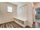 Mudroom with wood flooring, built in bench with storage, and a nearby window at 108 Ellsworth Rd # 40, Mooresville, NC 28115