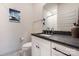 Well-lit bathroom featuring a modern vanity with a black countertop and ample storage at 1108 Wesley Terrace Ave, Charlotte, NC 28208