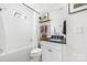 Bright bathroom featuring a tiled shower-tub, modern vanity, marble floors and stylish decor at 1108 Wesley Terrace Ave, Charlotte, NC 28208