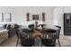 Elegant dining area with a round wooden table, black chairs, and decorative wine racks on the wall at 1108 Wesley Terrace Ave, Charlotte, NC 28208