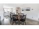Cozy dining area with a wooden table and black chairs, adjacent to a modern kitchen with white cabinets at 1108 Wesley Terrace Ave, Charlotte, NC 28208
