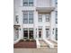 Modern white brick townhome with black framed windows and well-maintained landscaping at 1108 Wesley Terrace Ave, Charlotte, NC 28208