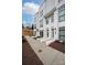 Street view showcasing modern townhouses with white exteriors and manicured landscaping at 1108 Wesley Terrace Ave, Charlotte, NC 28208