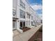Modern townhouse exterior showcasing large windows, white brick and manicured landscaping at 1108 Wesley Terrace Ave, Charlotte, NC 28208