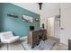 Comfortable home office with a large wooden desk and bright teal accent wall at 1108 Wesley Terrace Ave, Charlotte, NC 28208