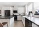 Bright kitchen with white cabinets, dark countertops, stainless steel appliances, and a breakfast bar at 1108 Wesley Terrace Ave, Charlotte, NC 28208