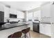 Modern kitchen featuring white cabinets, a dark countertop island, and stainless steel appliances at 1108 Wesley Terrace Ave, Charlotte, NC 28208