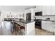 Contemporary kitchen featuring white cabinets, a dark island with seating, and stainless steel appliances at 1108 Wesley Terrace Ave, Charlotte, NC 28208