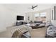 Inviting living room featuring a large gray sectional sofa, a stylish coffee table, and ample natural light at 1108 Wesley Terrace Ave, Charlotte, NC 28208