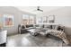 Spacious living room with a gray sectional sofa, a wooden coffee table, and large windows for natural light at 1108 Wesley Terrace Ave, Charlotte, NC 28208