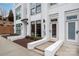 Inviting townhome featuring a white brick facade, well-manicured landscaping, and modern architectural details at 1108 Wesley Terrace Ave, Charlotte, NC 28208