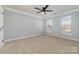 A light-filled bedroom with neutral carpet and a ceiling fan at 1245 Periwinkle Dr, Waxhaw, NC 28173