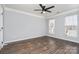 Bedroom features hardwood floors, a ceiling fan, and two windows at 1245 Periwinkle Dr, Waxhaw, NC 28173