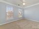 A naturally-lit bedroom featuring a ceiling fan and carpeted flooring at 1245 Periwinkle Dr, Waxhaw, NC 28173