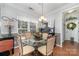 Charming dining room with a round glass table, chandelier, and large window offering natural light at 1245 Periwinkle Dr, Waxhaw, NC 28173