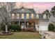 Charming two-story home featuring gray siding, blue shutters, a landscaped front yard and attached garage at 1245 Periwinkle Dr, Waxhaw, NC 28173