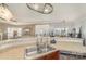 Open-concept kitchen featuring a stainless steel sink, modern fixtures, and a view into the living area at 1245 Periwinkle Dr, Waxhaw, NC 28173