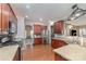 Updated kitchen features stainless steel appliances, updated cabinets, a hardwood floor, and a view into the dining room at 1245 Periwinkle Dr, Waxhaw, NC 28173