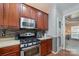 This kitchen features stainless steel appliances, updated cabinets, hardwood floors, and lots of counter space at 1245 Periwinkle Dr, Waxhaw, NC 28173