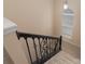 Carpeted staircase with decorative wrought iron railing leading to the upper level of the home at 1245 Periwinkle Dr, Waxhaw, NC 28173