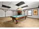 Basement game room featuring a pool table, brick fireplace, paneled ceiling, and a window with blinds at 126 Lynnwood Ln, Pineville, NC 28134