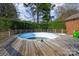 An empty in-ground pool with a wood deck creates a peaceful backyard retreat at 126 Lynnwood Ln, Pineville, NC 28134