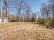 Large backyard featuring open space and trees in a natural setting at 13470 Austin Rd, Locust, NC 28097