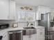 Kitchen area showcasing stainless steel appliances, a sink with a window view, and bright countertops at 13470 Austin Rd, Locust, NC 28097