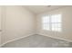 Neutral bedroom with a large double window and plush carpet at 14713 Lions Pride Ct, Charlotte, NC 28273