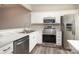 Modern kitchen boasts stainless steel appliances, white cabinetry, and marble countertops at 14713 Lions Pride Ct, Charlotte, NC 28273