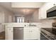 Open-concept kitchen featuring stainless steel appliances, marble countertops, and connection to living area at 14713 Lions Pride Ct, Charlotte, NC 28273