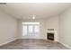 Cozy living room with wood flooring, a fireplace, and natural light from the french doors to the backyard at 14713 Lions Pride Ct, Charlotte, NC 28273