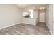 Open-concept living space with wood flooring, a modern chandelier, and a view of the kitchen at 14713 Lions Pride Ct, Charlotte, NC 28273