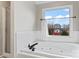 Bright bathroom featuring a soaking tub with jets near a large window and a separate shower at 1511 35Th Ne Ave, Hickory, NC 28601