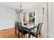 Bright dining room with a marble-top table, modern chandelier, and views of the landscaped backyard at 1511 35Th Ne Ave, Hickory, NC 28601