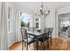 Bright dining room with a marble-top table, modern chandelier, and views of the landscaped backyard at 1511 35Th Ne Ave, Hickory, NC 28601