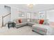 Spacious living room with a large gray sectional sofa, stylish lighting, and staircase at 1511 35Th Ne Ave, Hickory, NC 28601