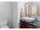 Stylish powder room featuring a vessel sink, wooden vanity, elegant mirror, and modern fixtures at 1511 35Th Ne Ave, Hickory, NC 28601